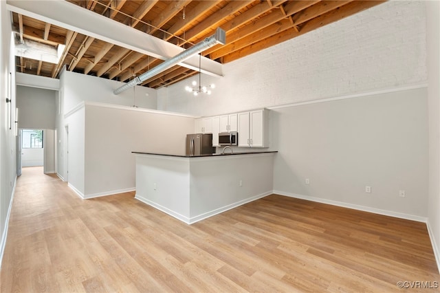1716 Summit Ave Unit 4, Richmond, VA 23230 - basement featuring freestanding refrigerator and light wood-style floors