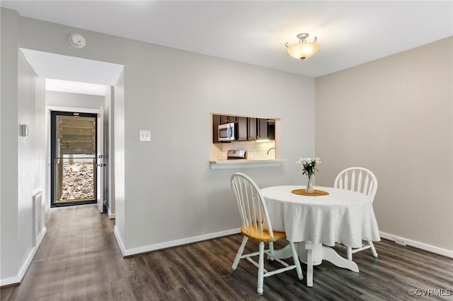 10152 Iron Mill Rd, North Chesterfield, VA 23235 - dining room featuring dark wood-type flooring and baseboards