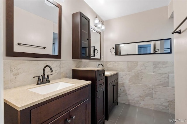 10152 Iron Mill Rd, North Chesterfield, VA 23235 - full bathroom with tile walls, two vanities, tile patterned floors, and a wainscoted wall