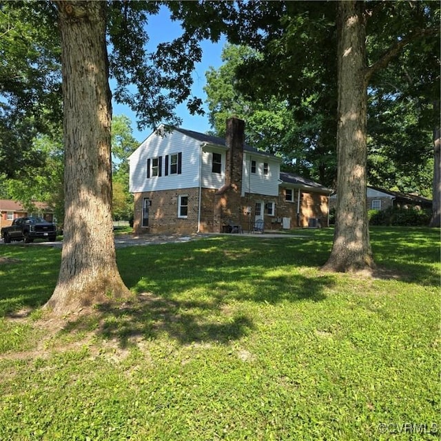 14300 Rosebud Rd, Chesterfield, VA 23838 - view of front of property with a chimney, a front lawn, and brick siding