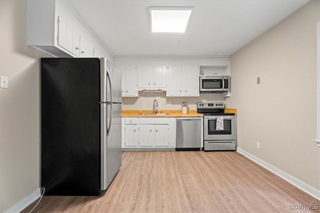 12707 Southwick Pl, Midlothian, VA 23113 - kitchen featuring appliances with stainless steel finishes, light wood finished floors, light countertops, and white cabinets