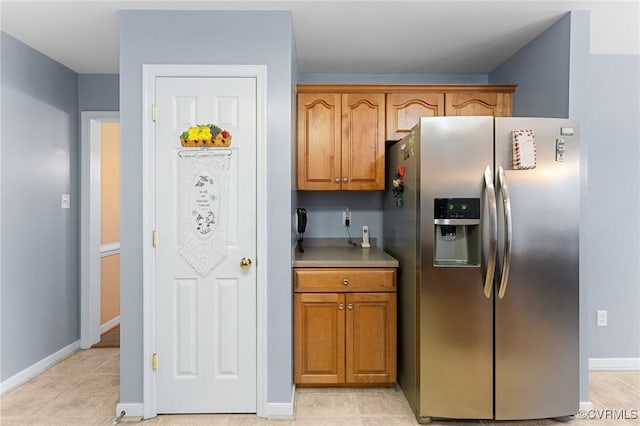 15619 Winding Ash Dr, Chesterfield, VA 23832 - kitchen with stainless steel refrigerator with ice dispenser, brown cabinets, and light tile patterned flooring