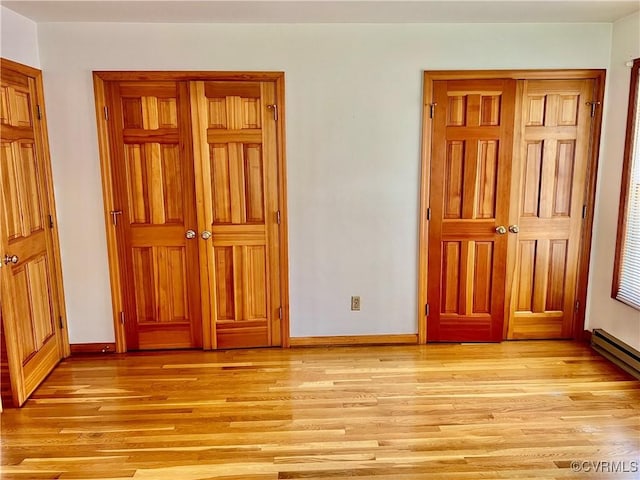 8426 Forge Rd, Henrico, VA 23228 - unfurnished bedroom with light wood finished floors and a baseboard radiator