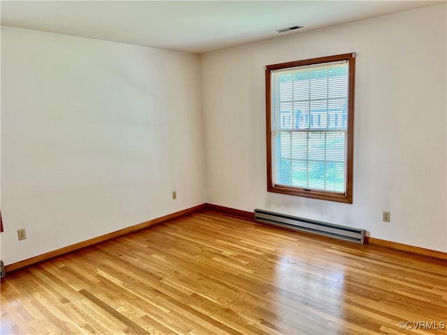 8426 Forge Rd, Henrico, VA 23228 - empty room with a baseboard radiator and light wood-type flooring