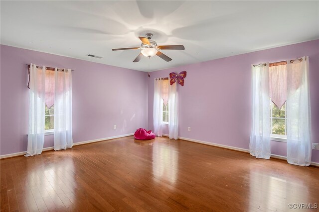 419 Carter Ln, Louisa, VA 23093 - empty room with healthy amount of natural light, a ceiling fan, and wood finished floors