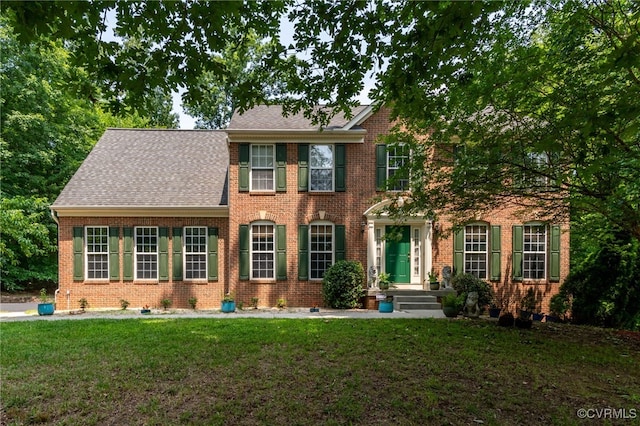 419 Carter Ln, Louisa, VA 23093 - view of front of house with brick siding, a front yard, roof with shingles, and crawl space