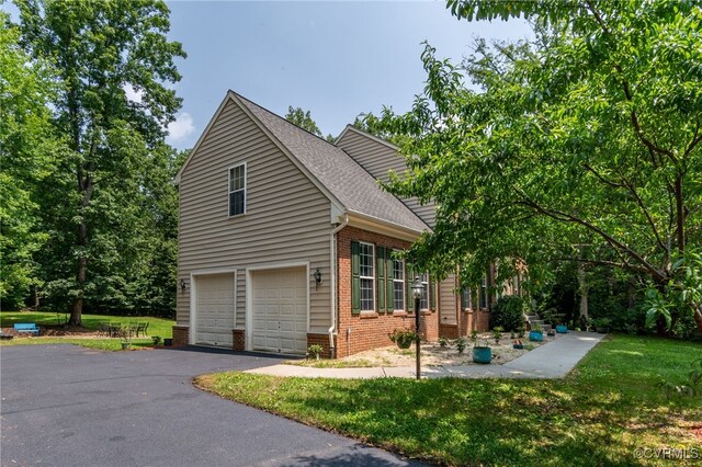 419 Carter Ln, Louisa, VA 23093 - view of side of property featuring brick siding, asphalt driveway, an attached garage, roof with shingles, and a yard