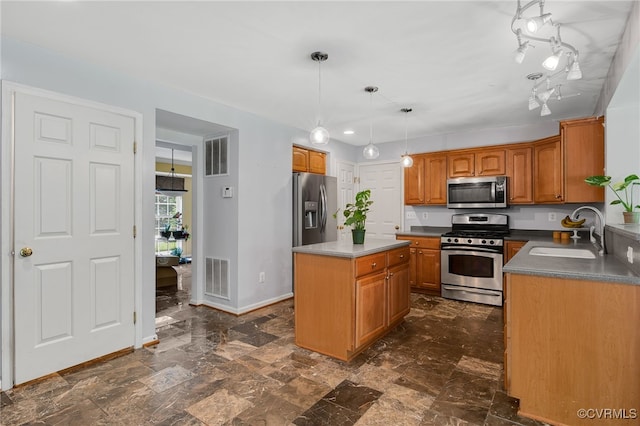 419 Carter Ln, Louisa, VA 23093 - kitchen featuring appliances with stainless steel finishes, brown cabinets, a kitchen island, and pendant lighting