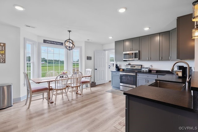9530 Dabneys Mill Rd, Manquin, VA 23106 - kitchen featuring appliances with stainless steel finishes, dark countertops, hanging light fixtures, light wood finished floors, and recessed lighting