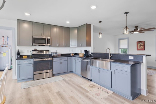 9530 Dabneys Mill Rd, Manquin, VA 23106 - kitchen featuring stainless steel appliances, electric water heater, a peninsula, dark countertops, and light wood-type flooring