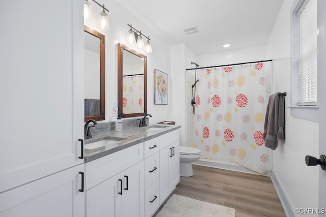 9530 Dabneys Mill Rd, Manquin, VA 23106 - full bath with wood finished floors, double vanity, a shower with curtain, and recessed lighting