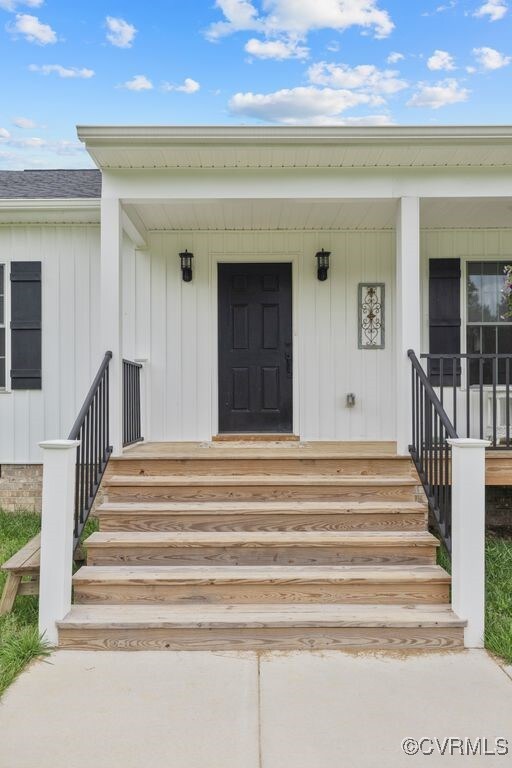 9530 Dabneys Mill Rd, Manquin, VA 23106 - property entrance featuring a porch, board and batten siding, and a shingled roof