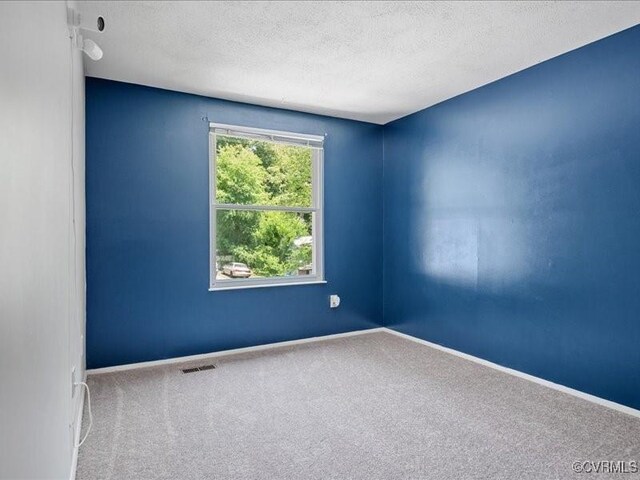 8507 Spruce Pine Dr, North Chesterfield, VA 23235 - empty room with carpet flooring and a textured ceiling