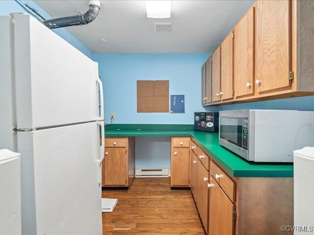 8507 Spruce Pine Dr, North Chesterfield, VA 23235 - kitchen with freestanding refrigerator, stainless steel microwave, a baseboard radiator, light wood finished floors, and electric panel