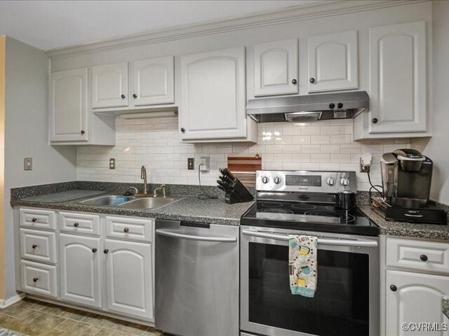 8507 Spruce Pine Dr, North Chesterfield, VA 23235 - kitchen with stainless steel appliances, dark countertops, under cabinet range hood, white cabinets, and decorative backsplash