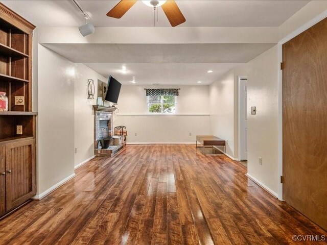8507 Spruce Pine Dr, North Chesterfield, VA 23235 - unfurnished living room with wood finished floors, ceiling fan, a fireplace with raised hearth, and track lighting