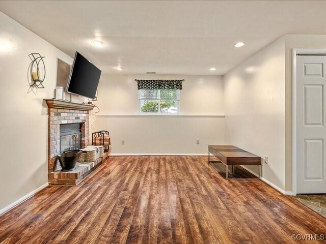 8507 Spruce Pine Dr, North Chesterfield, VA 23235 - unfurnished living room featuring wood finished floors, a brick fireplace, and recessed lighting