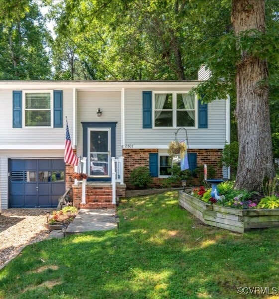 8507 Spruce Pine Dr, North Chesterfield, VA 23235 - split foyer home with brick siding, a front lawn, and an attached garage