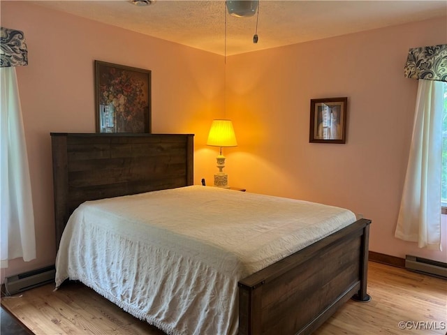 17800 Fraher Ln, Amelia Courthouse, VA 23002 - bedroom with baseboard heating and wood finished floors
