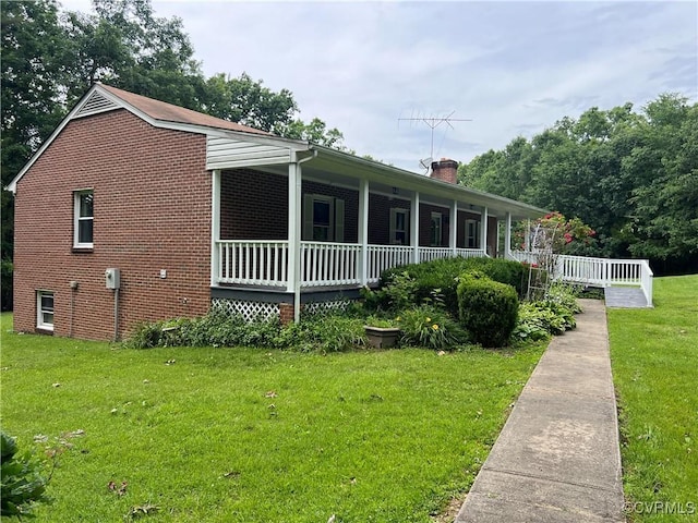 17800 Fraher Ln, Amelia Courthouse, VA 23002 - view of property exterior with a porch, a lawn, a chimney, and brick siding