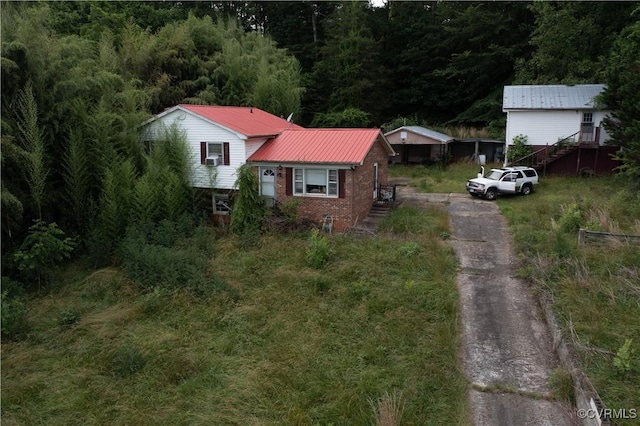 549 Ararat Hwy, Patrick Springs, VA 24053 - view of front of home featuring a metal roof, stairway, asphalt driveway, brick siding, and a wooded view