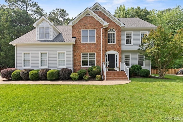 9563 Plateau Pl, Mechanicsville, VA 23116 - view of front of home featuring a front yard, brick siding, and a shingled roof