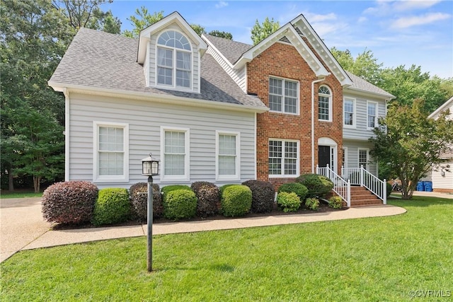 9563 Plateau Pl, Mechanicsville, VA 23116 - view of front facade featuring a front lawn, roof with shingles, and brick siding
