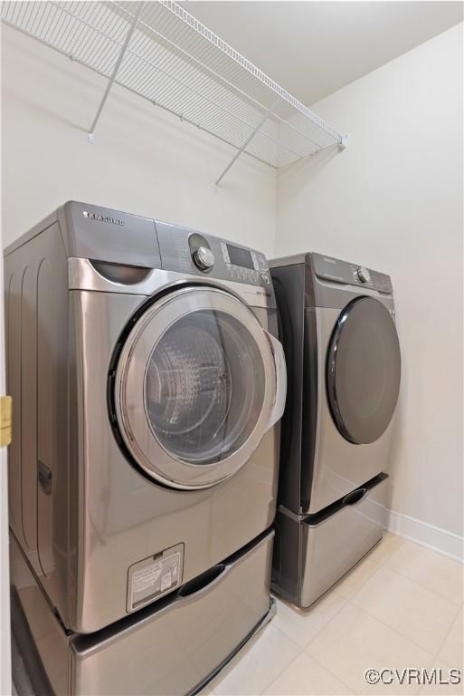 9563 Plateau Pl, Mechanicsville, VA 23116 - laundry area with washing machine and clothes dryer and tile patterned flooring