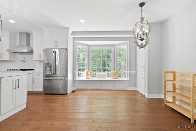 9563 Plateau Pl, Mechanicsville, VA 23116 - kitchen featuring high end fridge, wall chimney exhaust hood, white cabinets, a chandelier, and recessed lighting