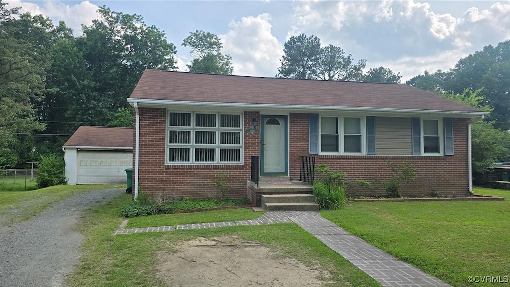 2605 Fruehauf Rd, Henrico, VA 23228 - view of front facade featuring brick siding, a front lawn, an outdoor structure, driveway, and a garage