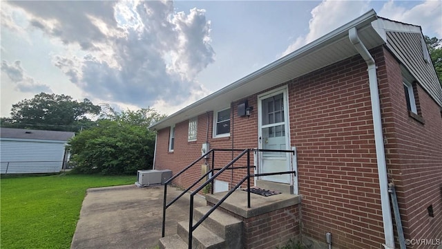 2605 Fruehauf Rd, Henrico, VA 23228 - rear view of property featuring a patio area, a lawn, and brick siding