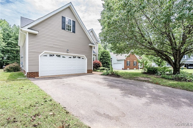 7618 Old Track Ln, Mechanicsville, VA 23111 - view of property exterior featuring asphalt driveway, an attached garage, and a yard