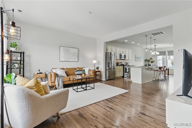 8045 Ellendale Dr, Mechanicsville, VA 23116 - living area featuring dark wood-style flooring, recessed lighting, and a chandelier