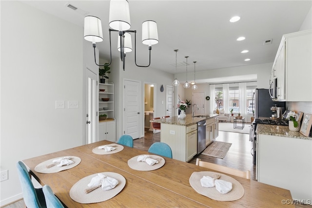8045 Ellendale Dr, Mechanicsville, VA 23116 - dining room featuring light wood finished floors and recessed lighting