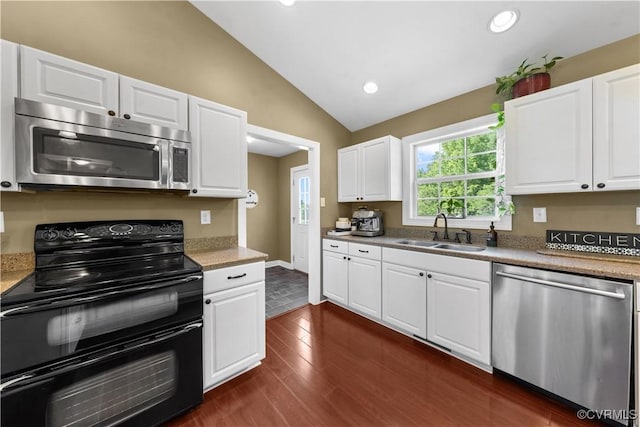 201 School Rd, Dillwyn, VA 23936 - kitchen with stainless steel appliances, vaulted ceiling, dark wood-type flooring, recessed lighting, and white cabinetry