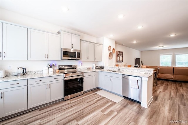 12325 Petrel Xing Unit 7, Midlothian, VA 23112 - kitchen with appliances with stainless steel finishes, open floor plan, a peninsula, light wood-style floors, and recessed lighting