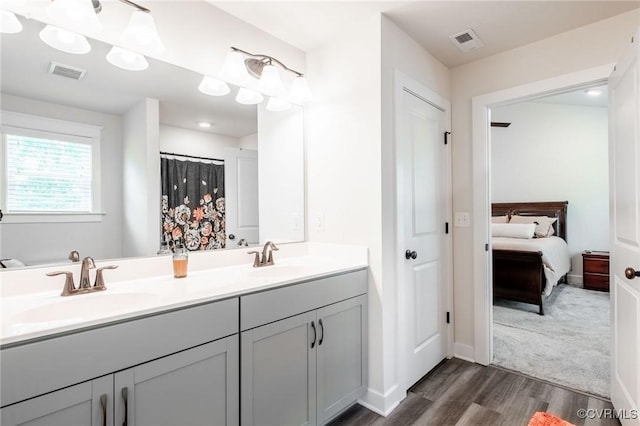 12325 Petrel Xing Unit 7, Midlothian, VA 23112 - bathroom featuring double vanity, wood finished floors, and ensuite bathroom