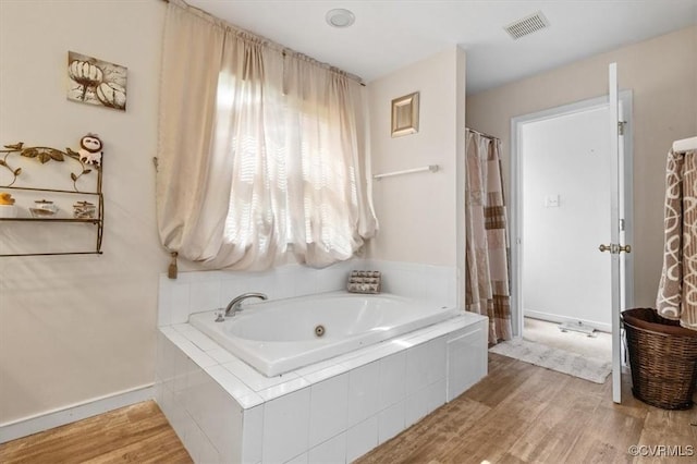 1408 Windrow Ct, Henrico, VA 23223 - bathroom featuring a whirlpool tub and wood finished floors