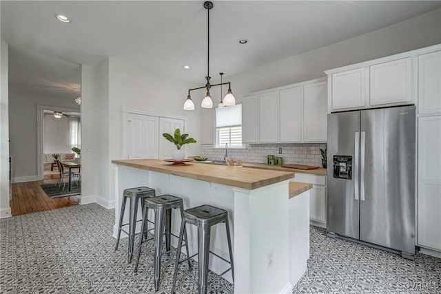 1111 N 23rd St, Richmond, VA 23223 - kitchen featuring stainless steel fridge with ice dispenser, wooden counters, a kitchen breakfast bar, backsplash, and recessed lighting