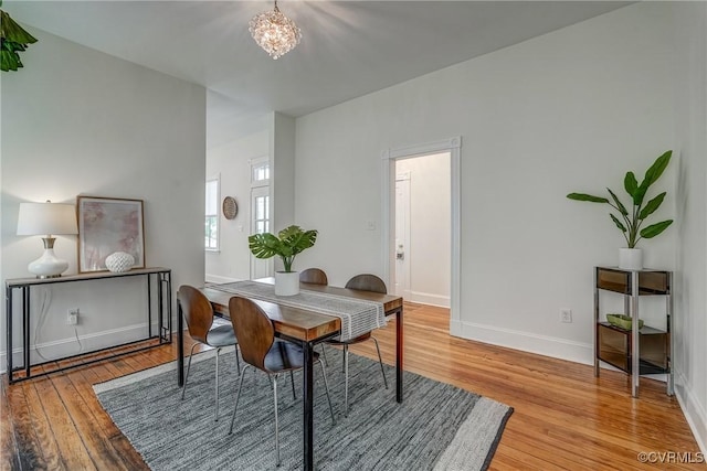 1111 N 23rd St, Richmond, VA 23223 - dining space featuring light wood-type flooring and a chandelier