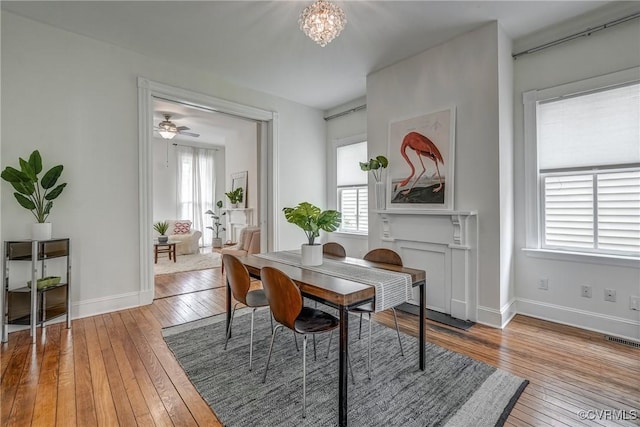 1111 N 23rd St, Richmond, VA 23223 - dining space with hardwood / wood-style floors, a chandelier, and ceiling fan