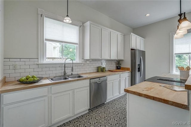 1111 N 23rd St, Richmond, VA 23223 - kitchen featuring butcher block countertops, stainless steel appliances, white cabinets, decorative backsplash, and recessed lighting