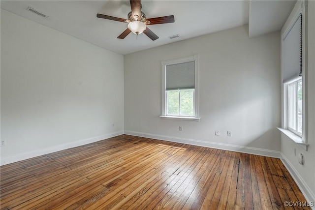 1111 N 23rd St, Richmond, VA 23223 - unfurnished room featuring plenty of natural light, hardwood / wood-style floors, and a ceiling fan