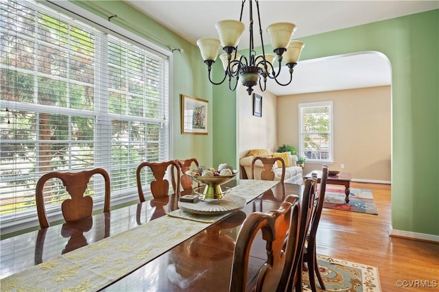 2024 Rose Family Dr, Midlothian, VA 23112 - dining space featuring arched walkways, wood finished floors, and a chandelier