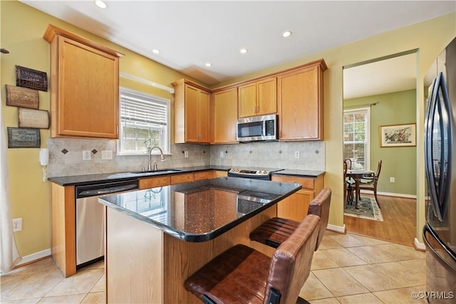 2024 Rose Family Dr, Midlothian, VA 23112 - kitchen with appliances with stainless steel finishes, light tile patterned floors, healthy amount of natural light, decorative backsplash, and recessed lighting