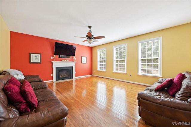 2024 Rose Family Dr, Midlothian, VA 23112 - living room with a ceiling fan, light wood-style floors, and a fireplace with flush hearth
