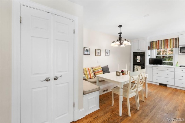 2740 Rettig Rd, Richmond, VA 23225 - dining space with light wood finished floors and a chandelier