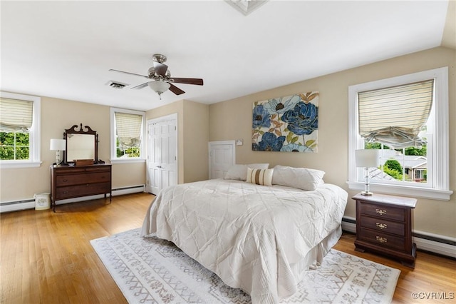 2740 Rettig Rd, Richmond, VA 23225 - bedroom featuring a baseboard heating unit, light wood-type flooring, a baseboard radiator, and a ceiling fan