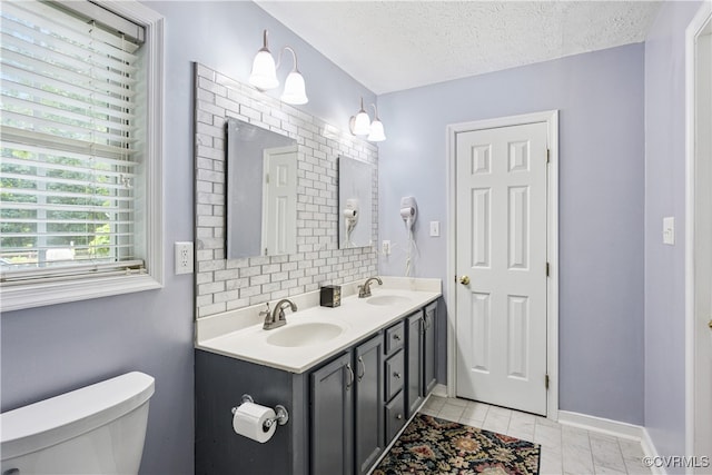 3826 Minitree Glen Dr, Providence Forge, VA 23140 - bathroom featuring double vanity, backsplash, and a textured ceiling