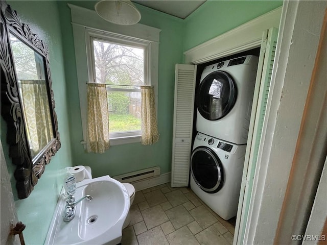 1527 National St, Richmond, VA 23231 - bathroom featuring estacked washer and dryer, a baseboard radiator, and stone finish flooring